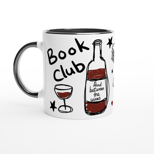 A white ceramic coffee mug with a black handle and black interior, decorated with a hand-drawn style illustration of a wine bottle, a glass of red wine, stars, and the words 'Book Club' and 'Read between the wines'.