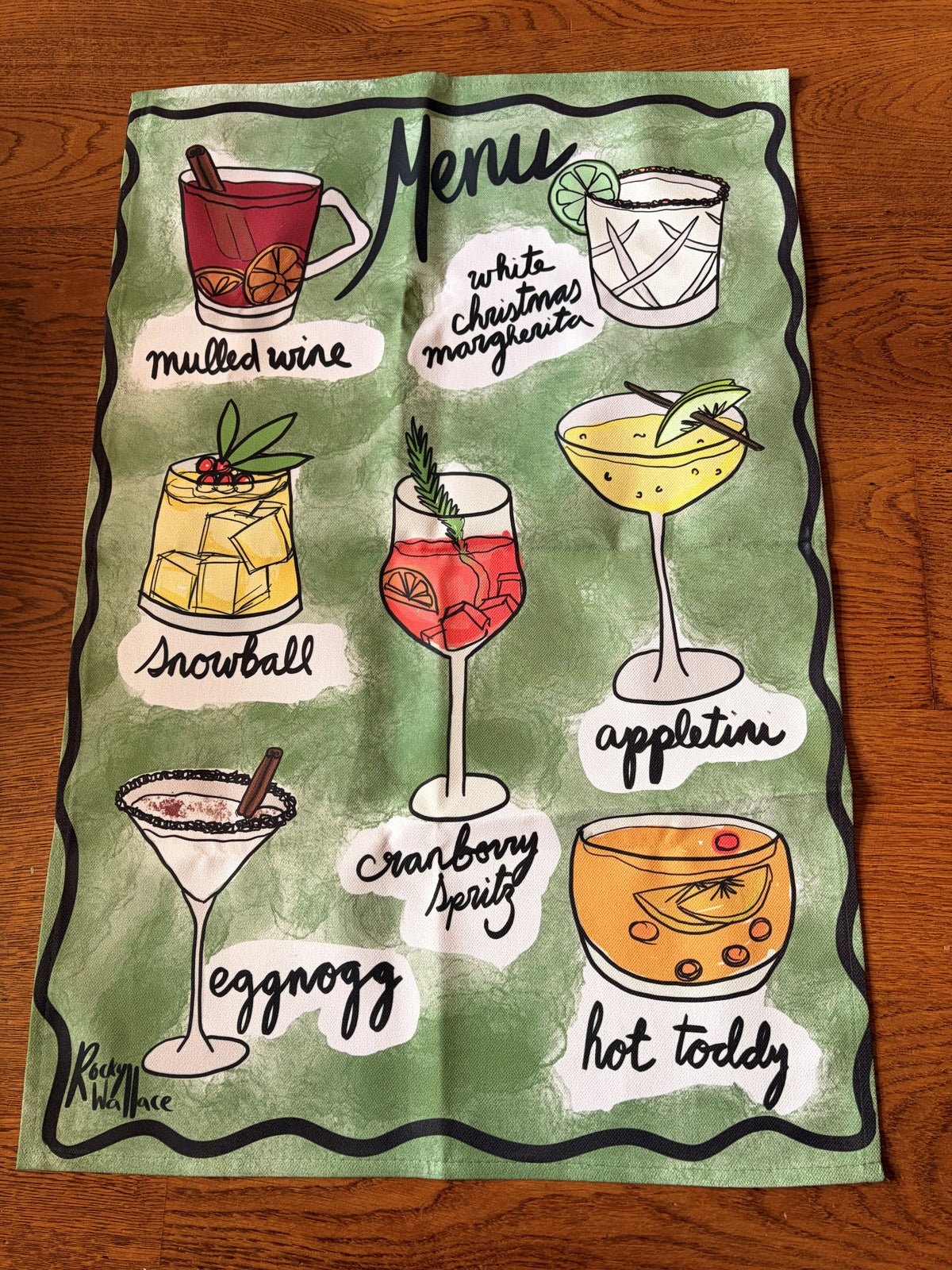 Christmas Cocktails Drinks Menu Tea Towel on a wooden floor